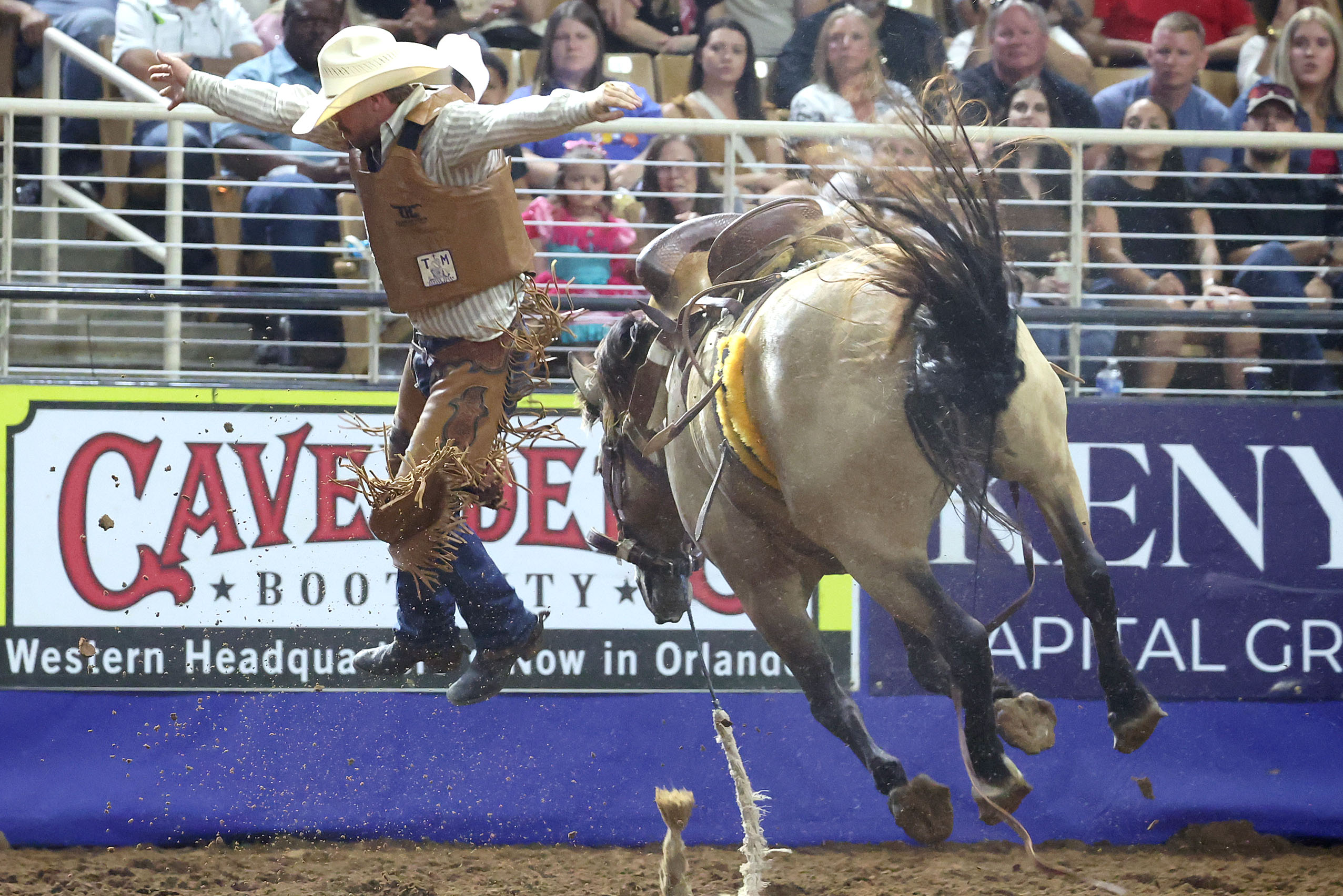 Hayden Hall leaps off a bucking bronc after his ride...