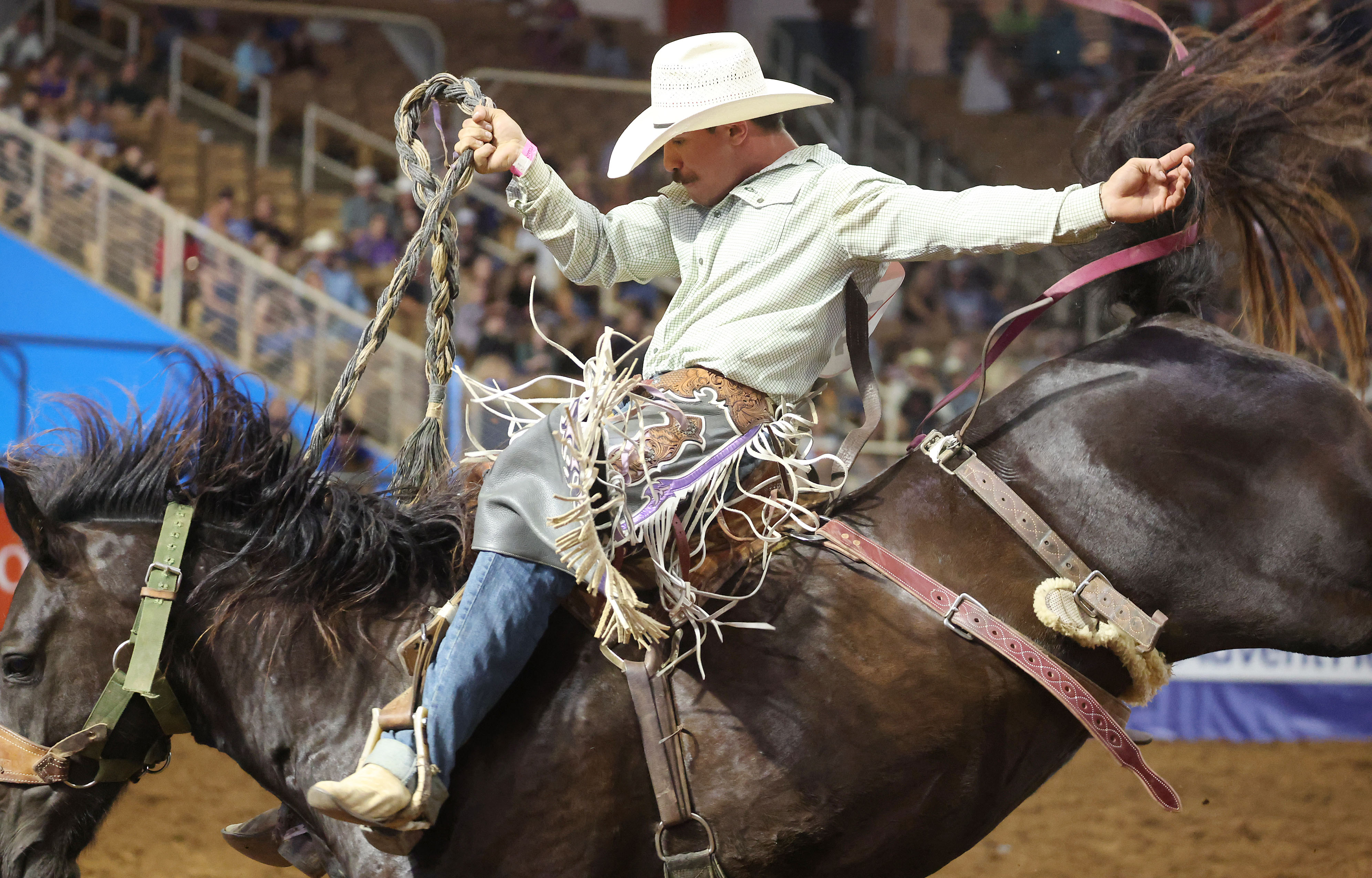 Wyatt Lavergne rides a bucking bronc during the Silver Spurs...