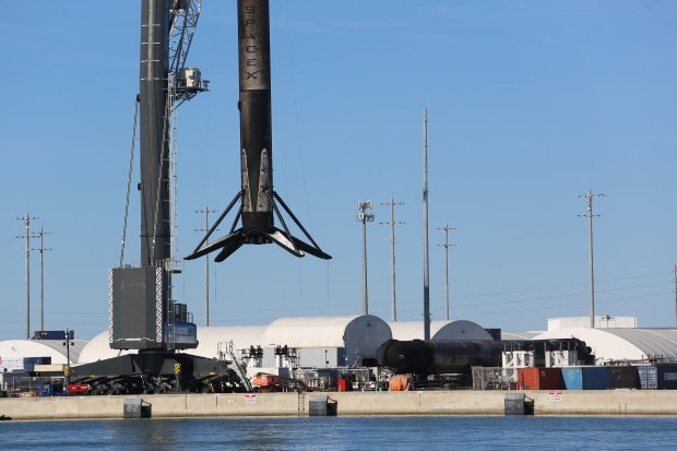 One of the three mobile harbor cranes at Port Canaveral lifts a SpaceX Falcon 9 booster off of a droneship Wednesday, Nov. 13, 2025, after it had returned from a recovery landing after a launch. (Richard Tribou/Orlando Sentinel)