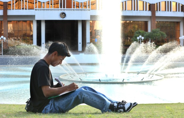 UCF student Jose Carrera studies at the reflection pond on campus on Wednesday, February 5, 2025. Carrera is a "Dreamer" and is at UCF studying to be a physicians assistant. He says he may have to abandon his studies and return to his birth country of Mexico if in-state tuition is repealed because it's too expensive. (Stephen M. Dowell/Orlando Sentinel)