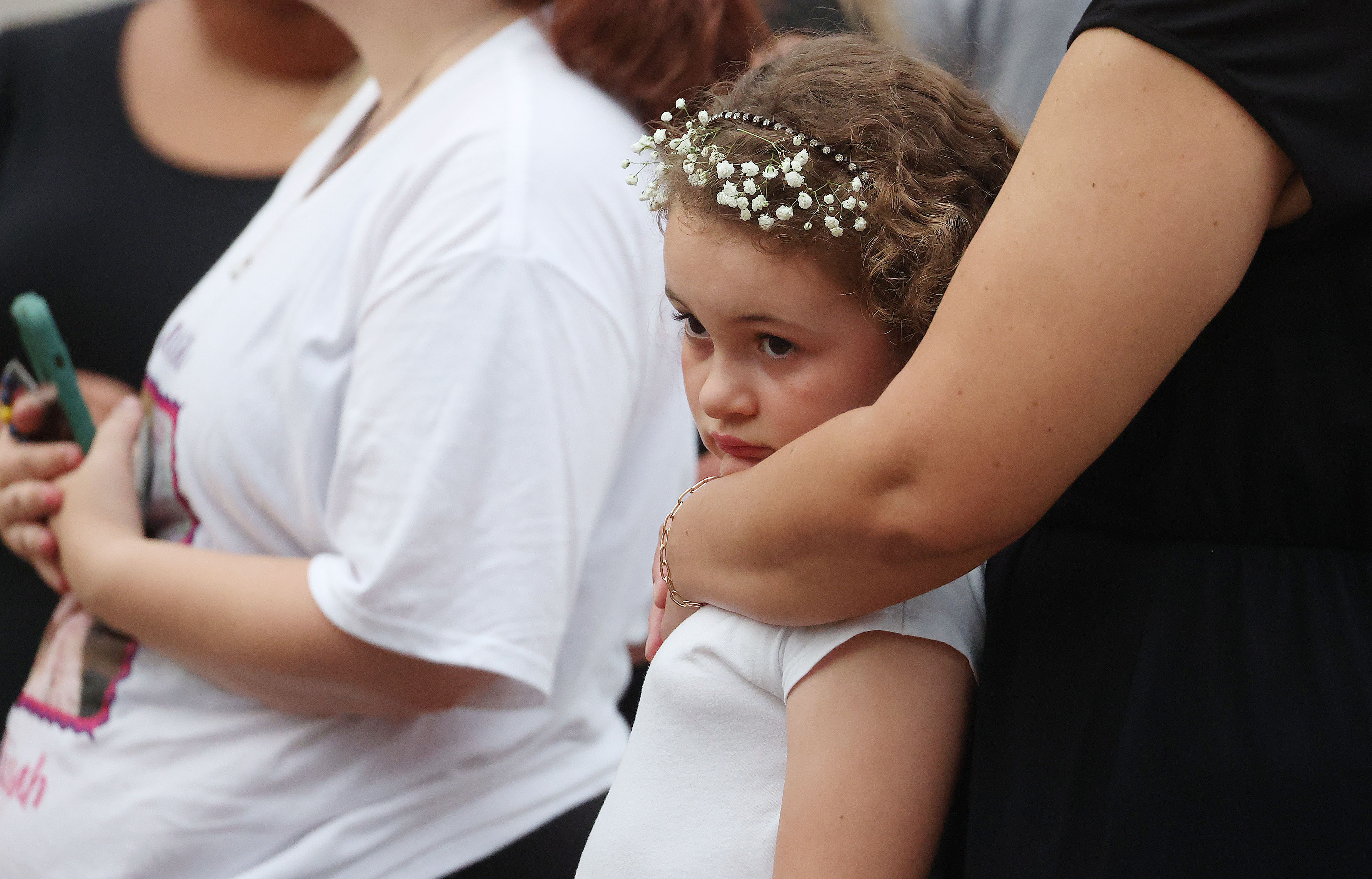 Mourners grieve during a community vigil for 2-year-old Tiana Rae...