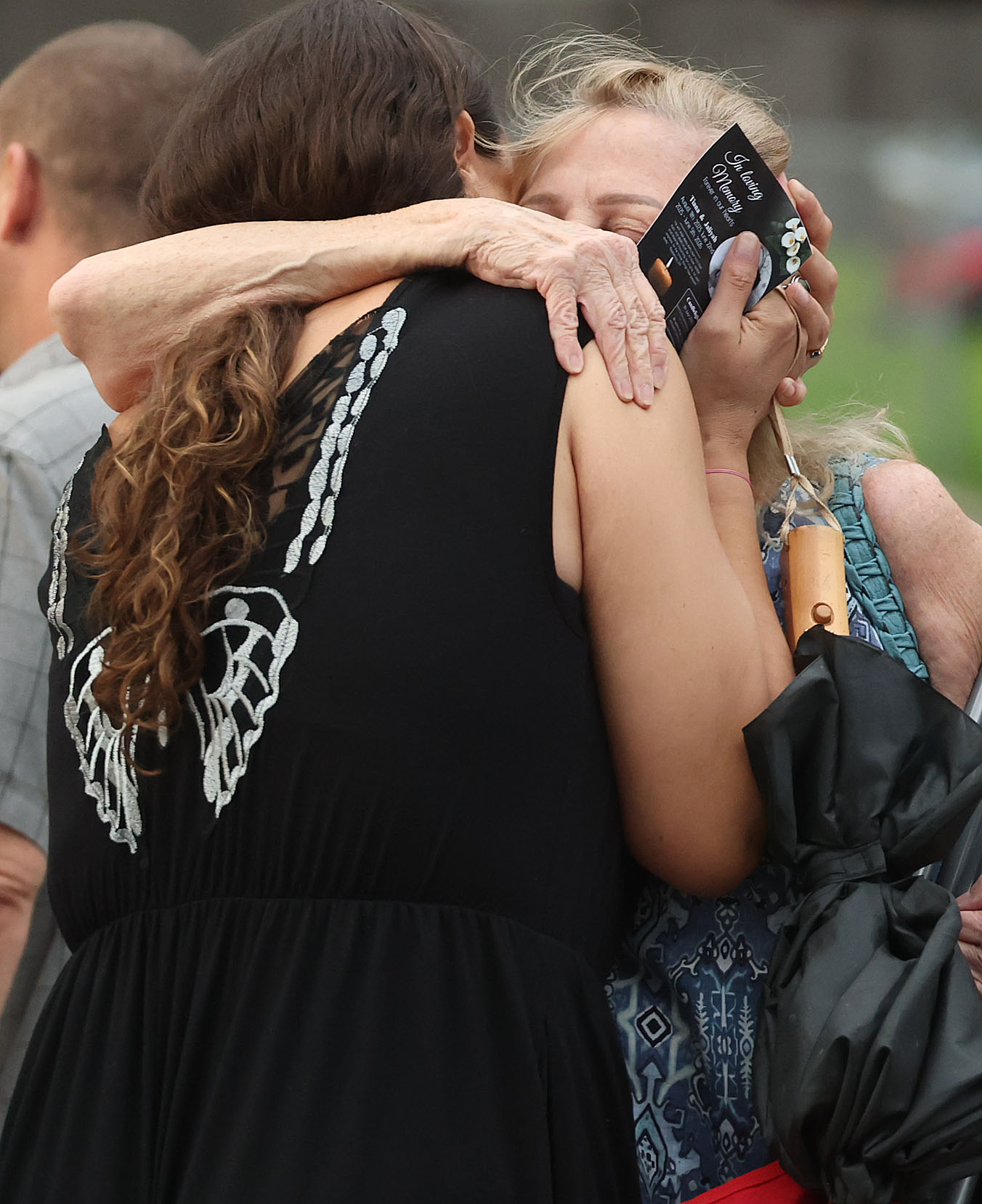 Mourners hugduring a community vigil for 2-year-old Tiana Rae Watts...