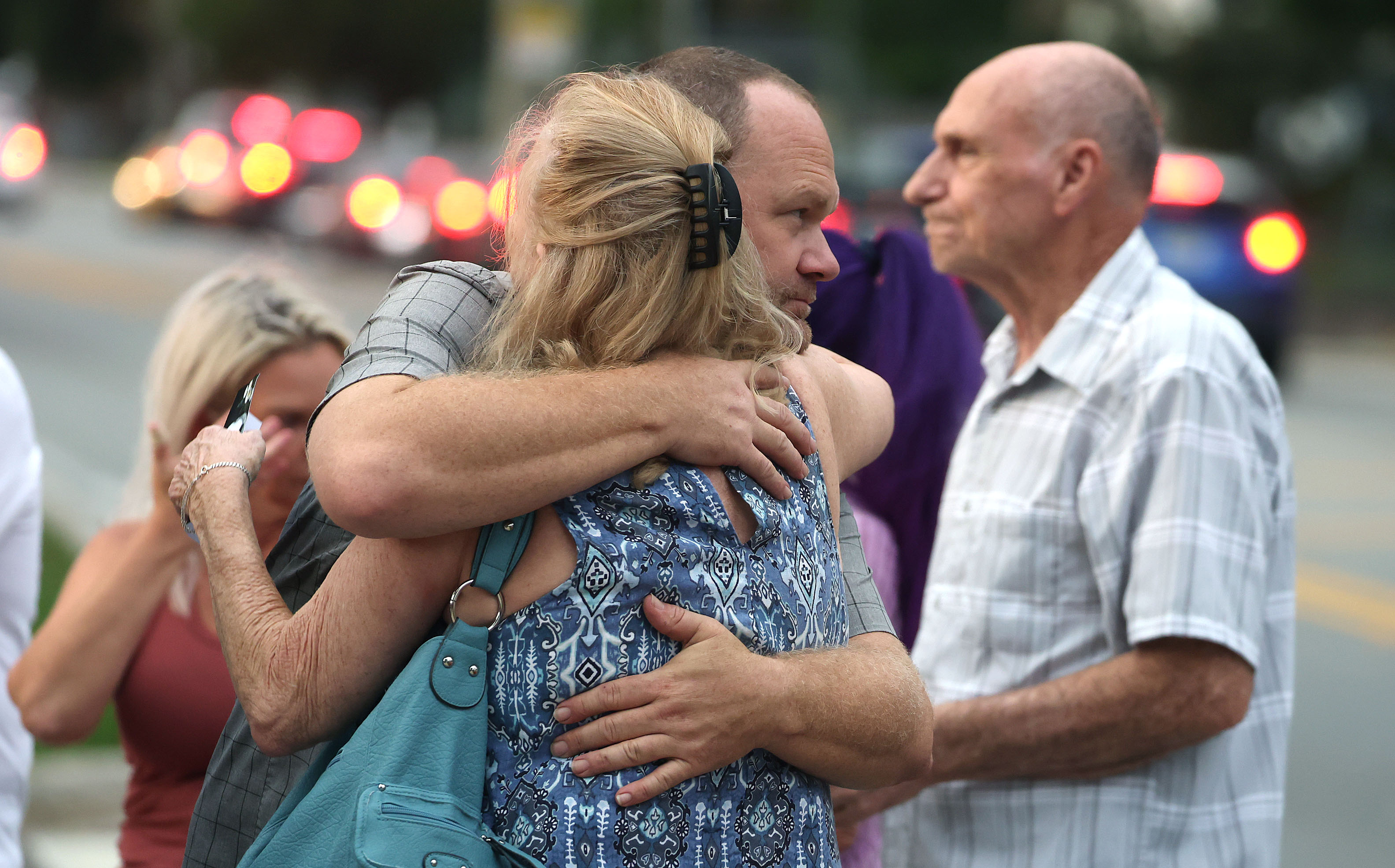 Mourners grieve during a community vigil for 2-year-old Tiana Rae...