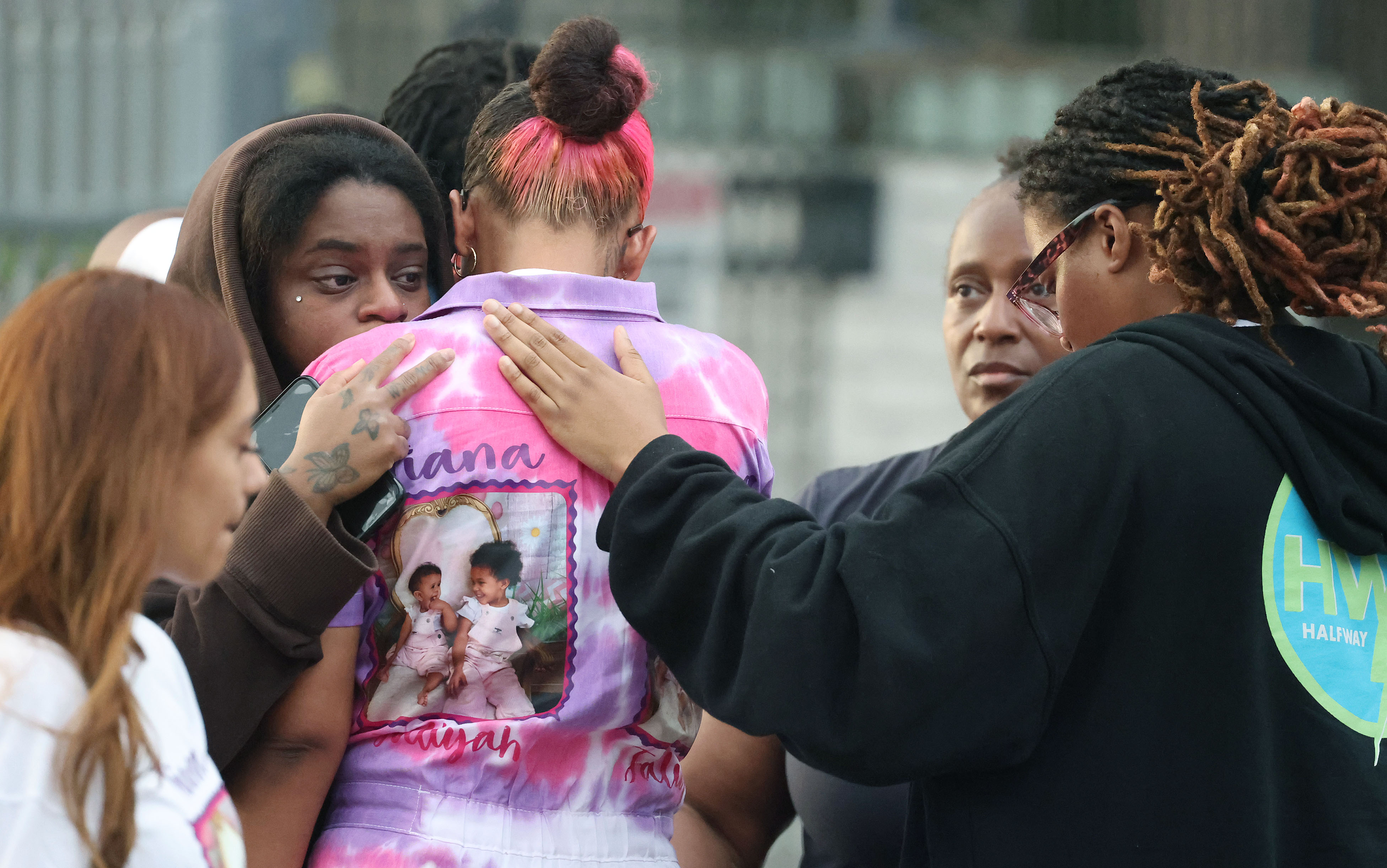 Mourners grieve during a community vigil for 2-year-old Tiana Rae...