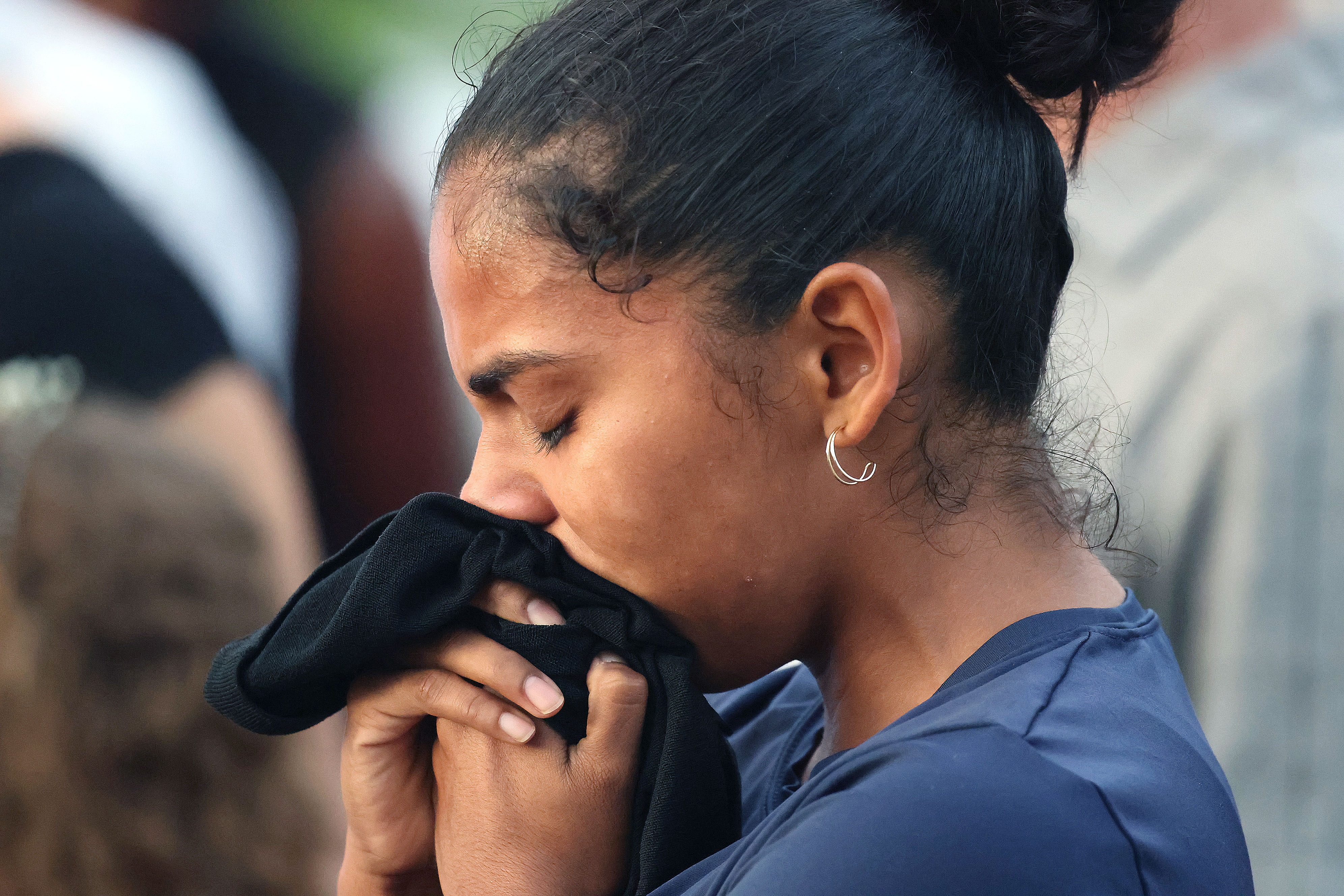 A mourner grieves during a community vigil for 2-year-old Tiana...