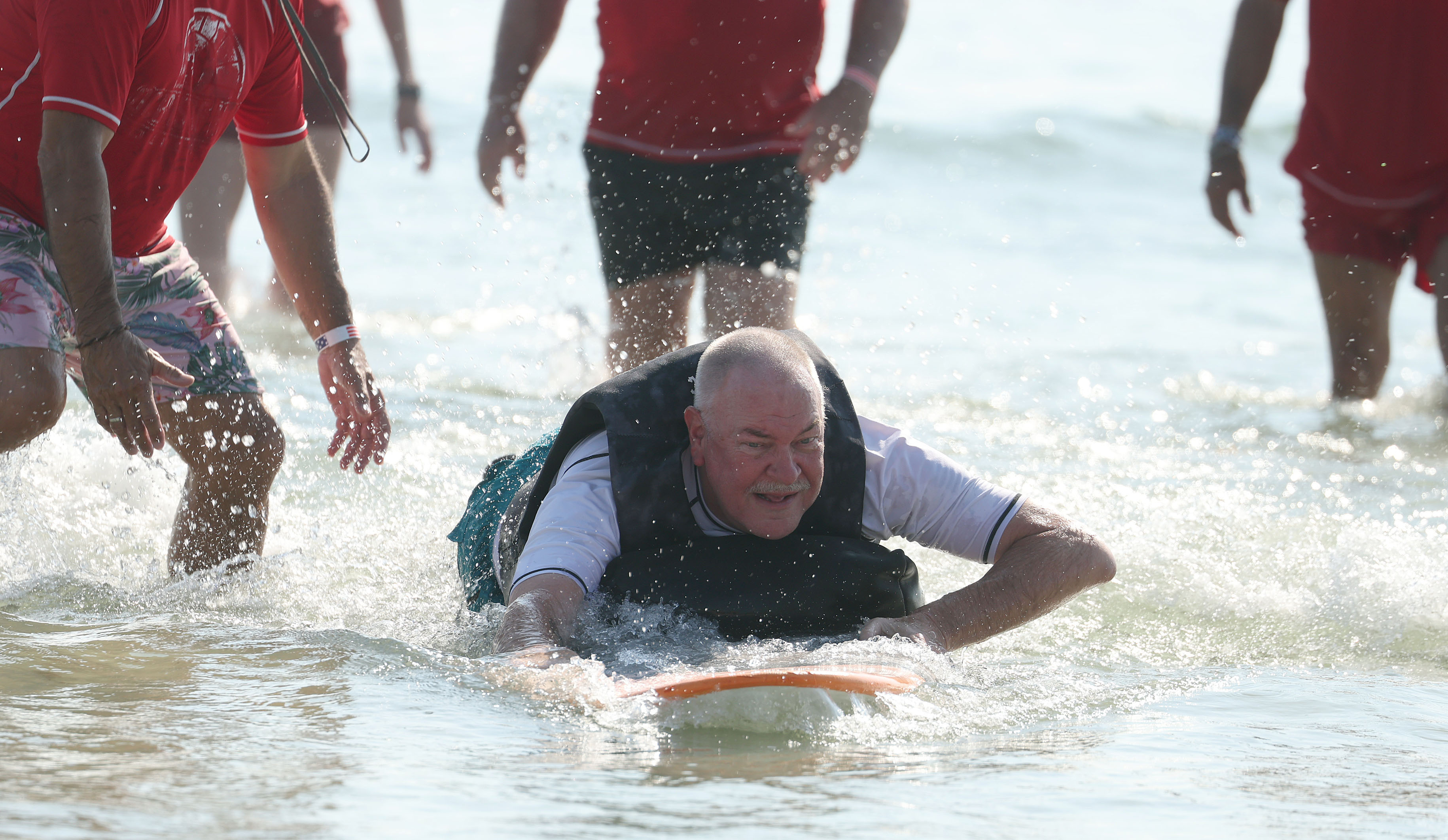 Navy veteran Rick Rettinger surfs at New Smyrna Beach on...