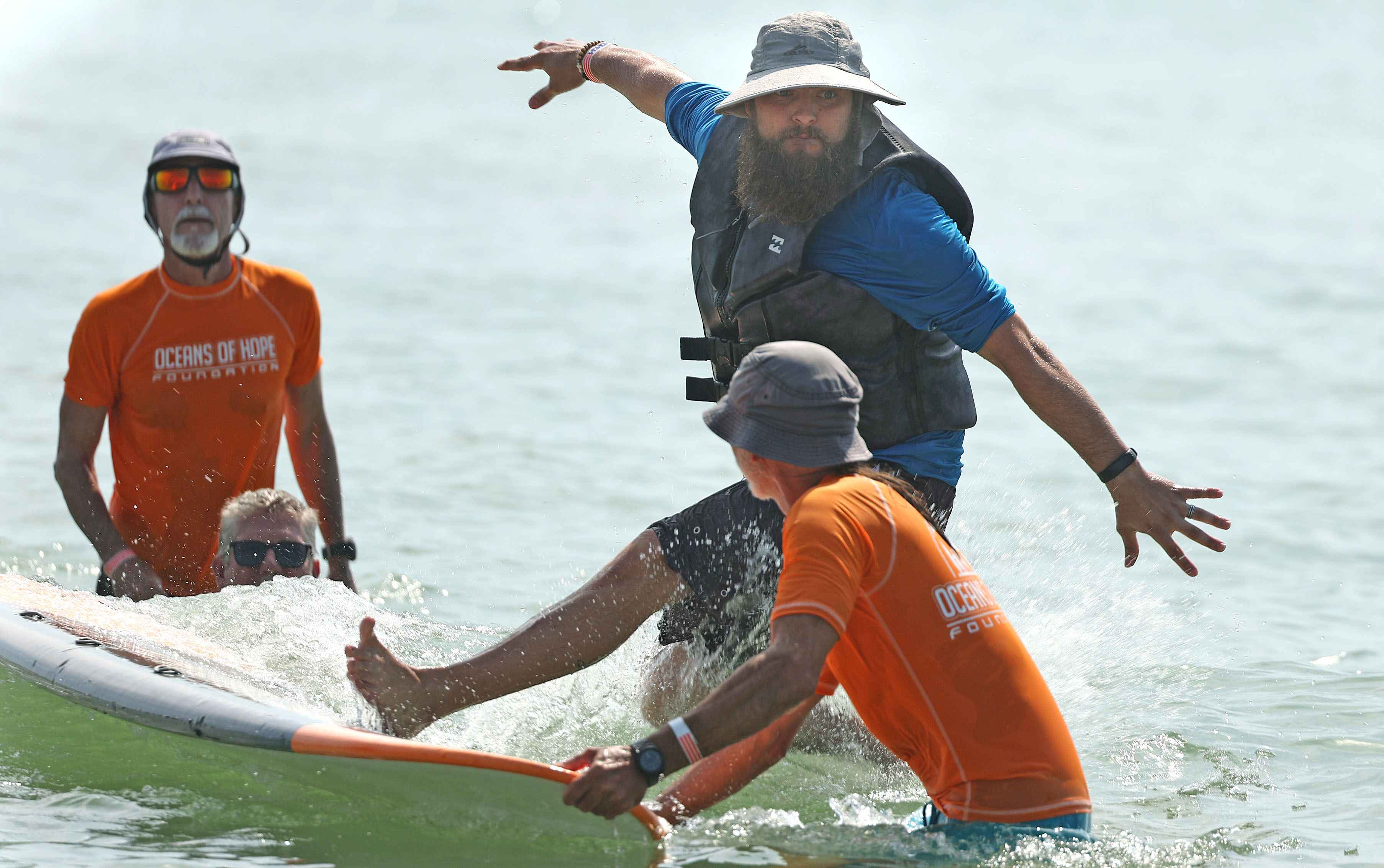 A wounded veteran takes a spill in the surf at...