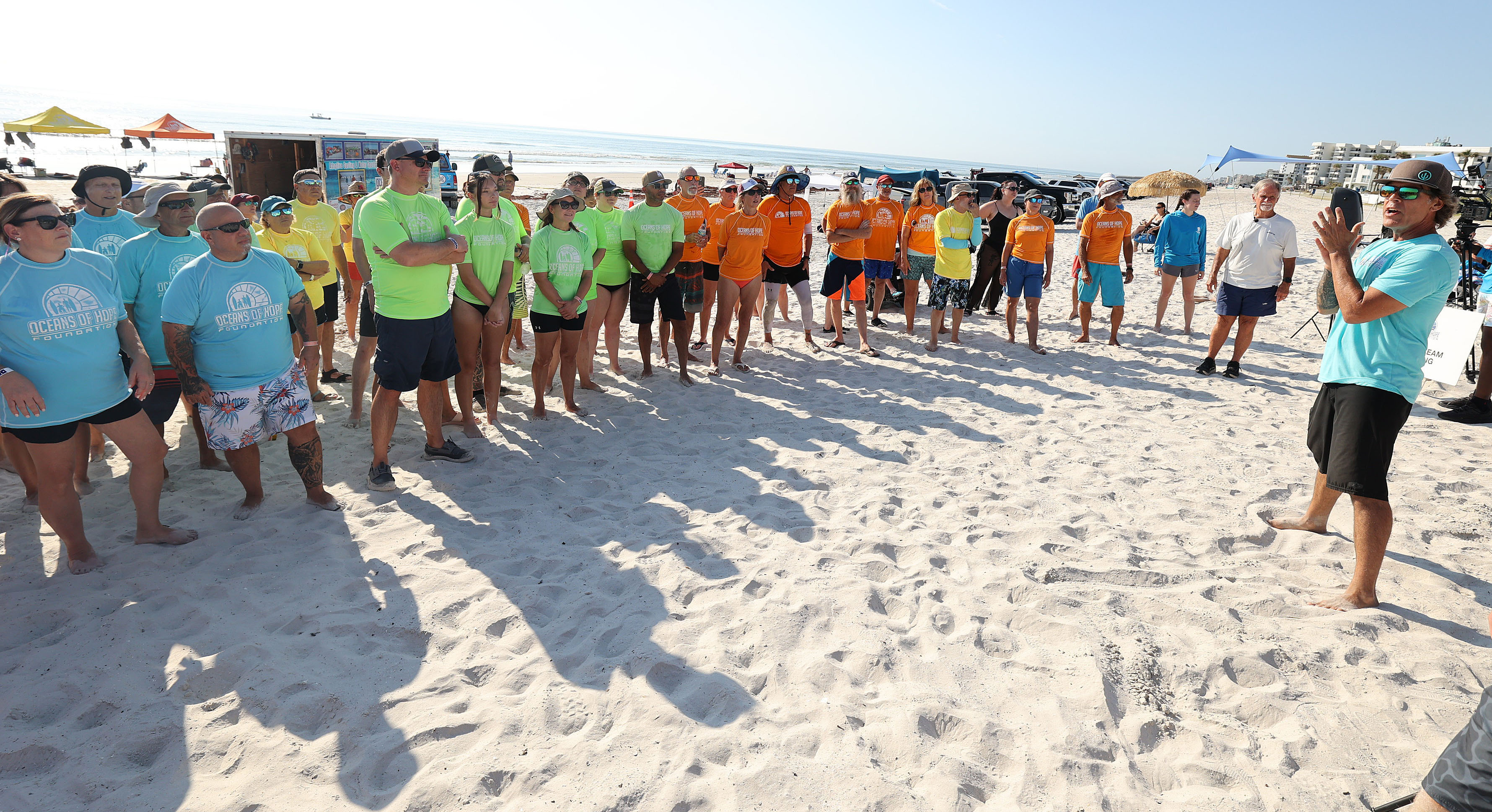 Volunteers receive instructions at New Smyrna Beach on Saturday, June...