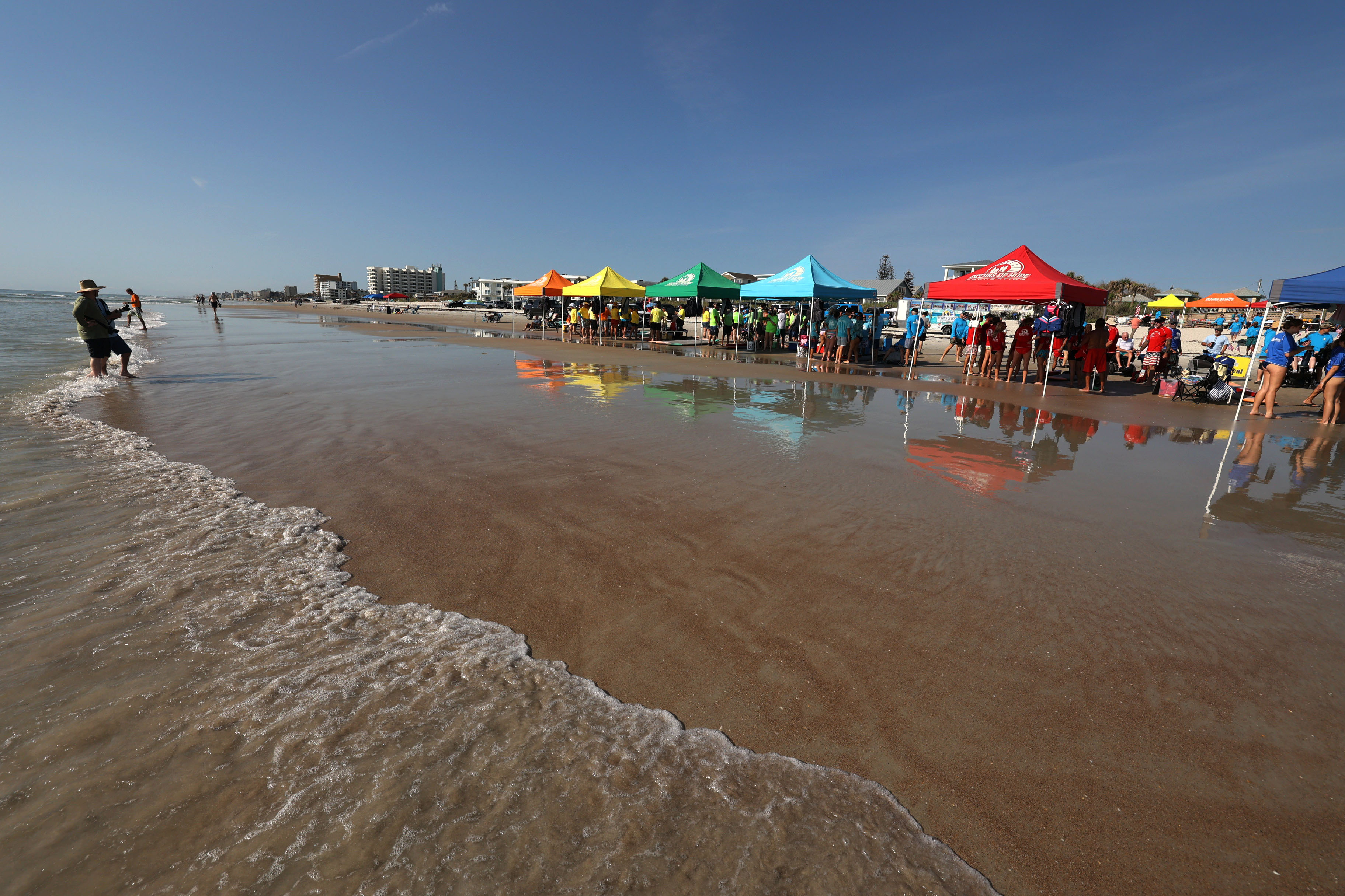 Colorful tents are set up at New Smyrna Beach on...