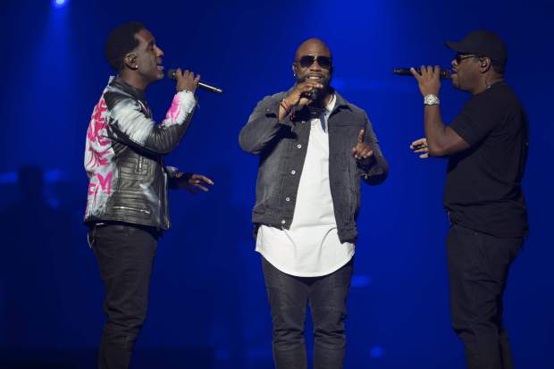 Shawn Stockton, left, Wanya Morris and Nathan Morris of Boyz II Men perform at the Vegas Strong Benefit concert at the T-Mobile Arena, Friday, Dec. 1, 2017 in Las Vegas. (Photo by Eric Jamison/Invision/AP)