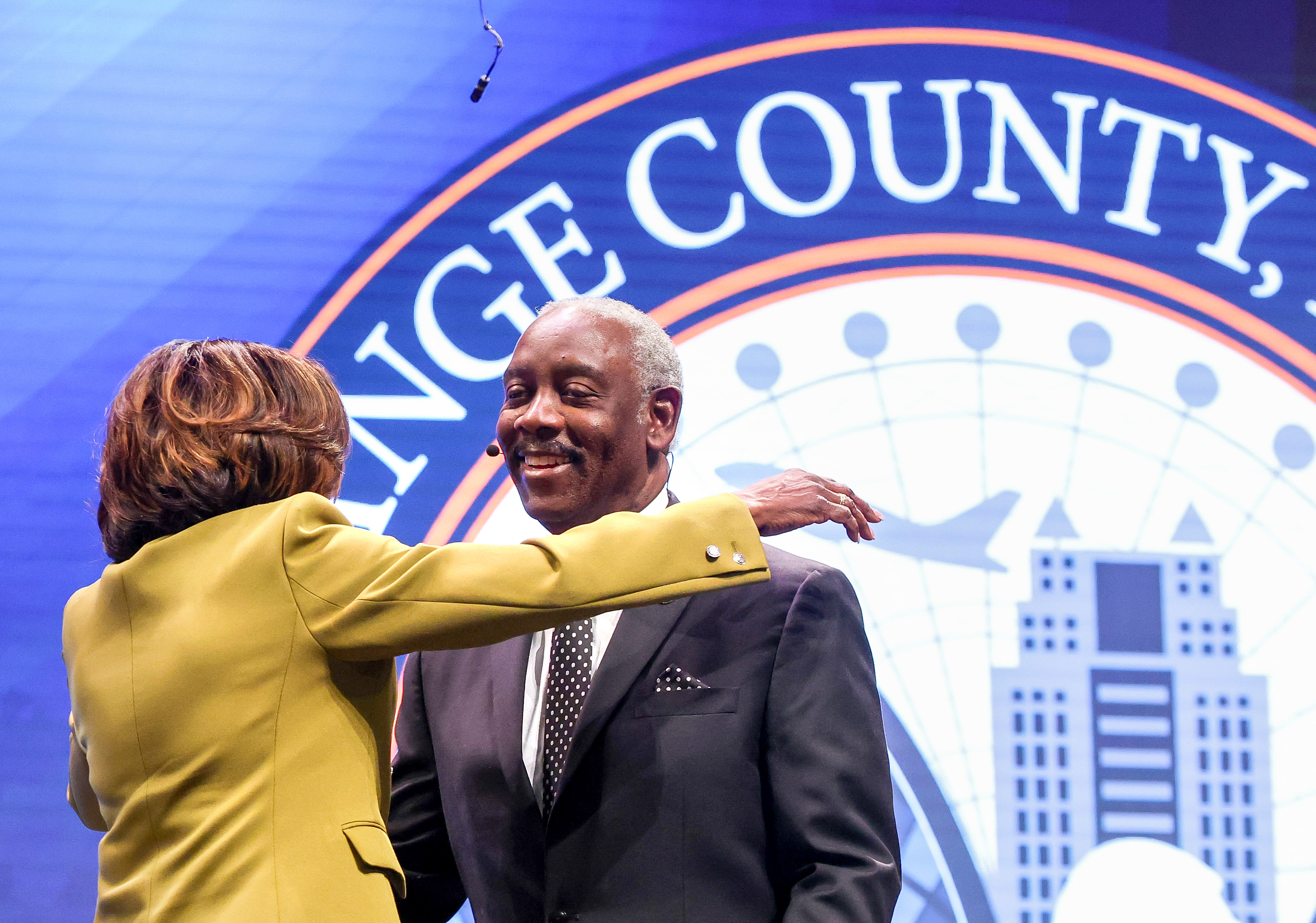 Orange County Mayor Jerry Demings gets a hug from Val...