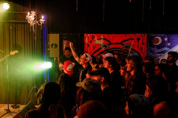 Attendees cheer while Arythmia the band performs at My Sister's House, a nonprofit DIY venue within Boardwalk Bowl in Orlando, on May 20, 2026. (Patrick Connolly/Orlando Sentinel)