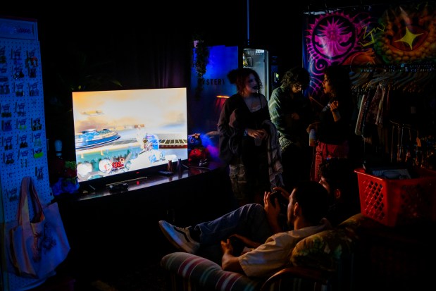 Concert attendees play video games and hang out at My Sister's House, a nonprofit DIY venue within Boardwalk Bowl in Orlando, on May 20, 2026. (Patrick Connolly/Orlando Sentinel)