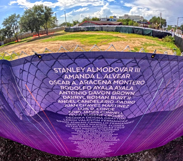 The names of the 49 patrons killed in the massacre are listed on construction netting at the site of the Orlando United Pulse Memorial on South Orange Avenue on May 27, 2026. The permanent memorial is slated to open by the end of 2027. (Joe Burbank/Orlando Sentinel)