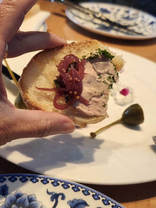 Chicken liver and foie gra pate comes with red onion mostarda and caperberries. (Amy Drew Thompson/Orlando Sentinel)