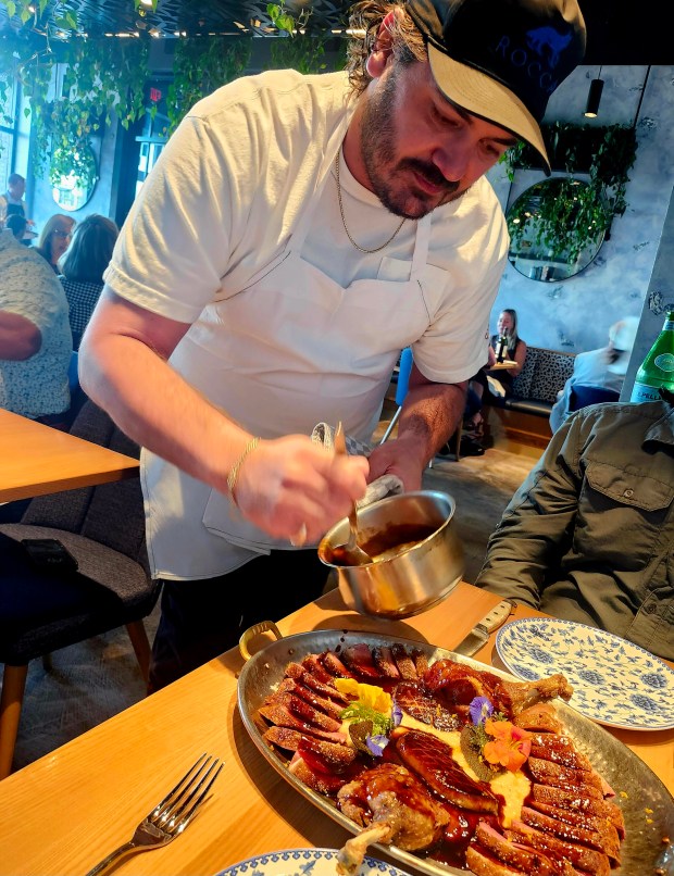 Rocca Executive Chef/Partner Bryce Bonsack dresses the dry-aged Rohan duck plattter during an early seating, which is offered in very limited quantities daily. Make an early reservation! (Amy Drew Thompson/Orlando Sentinel)