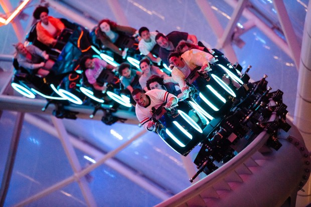 Magic Kingdom visitors hang on during the Tron Lightcycle / Run coaster during a Disney After Hours events at Magic Kingdom theme park. (Steven Diaz/Walt Disney Co.)