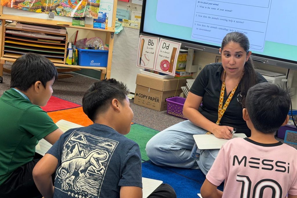 Teacher Vivian Lopes leads a small-group writing lesson at the Martin County School District's Summer Reading Camp. 