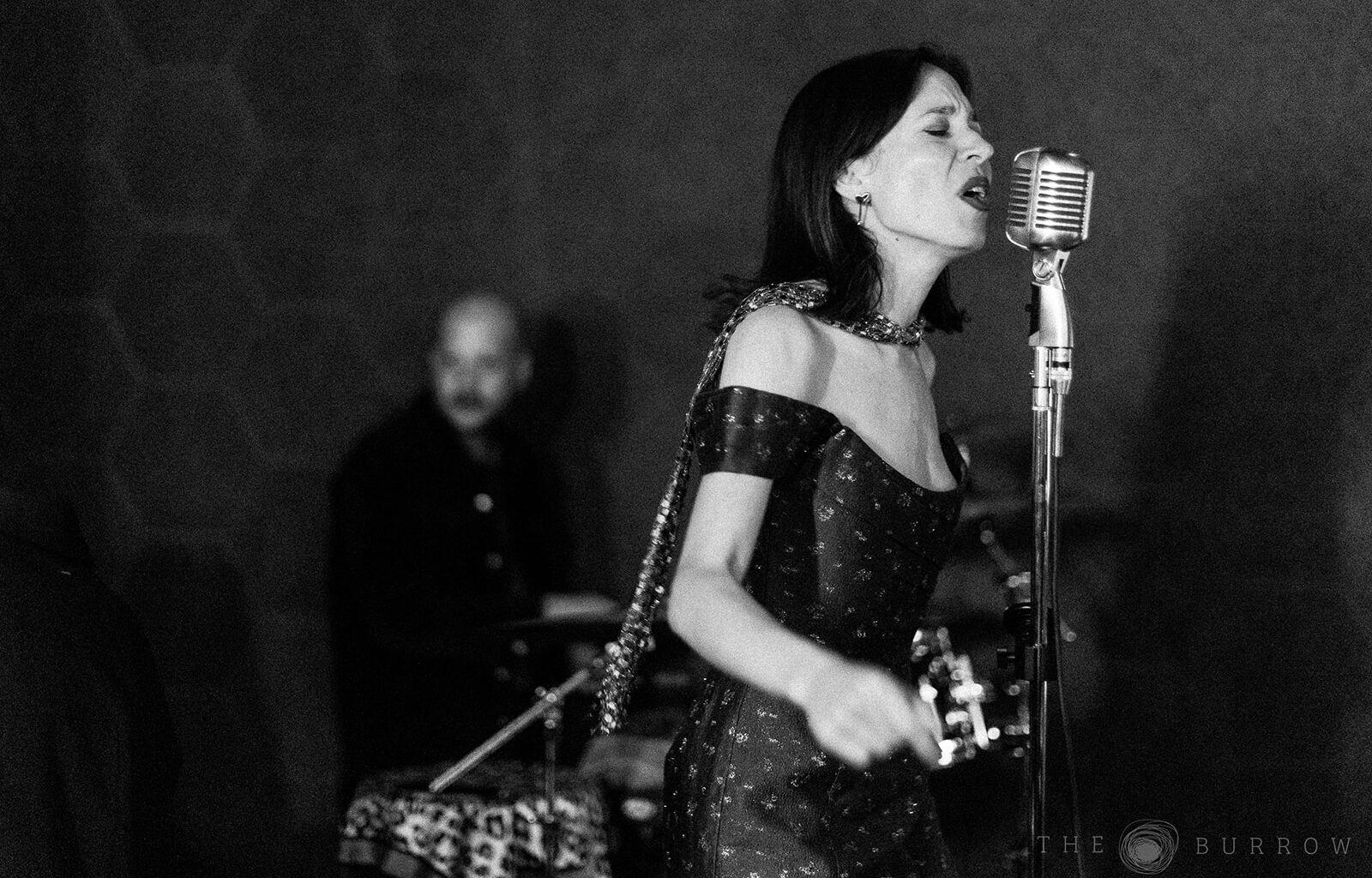 Photo of a jazz singer performing wearing a dress at the Burrow in Miami.