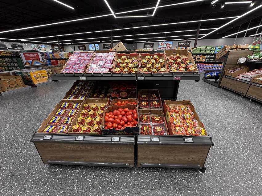 Fresh tomatoes dominate an endcap in the produce section.