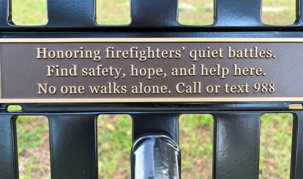 The plaque on The Bench reminds firefighters that they always have support and that "No one walks alone." (Scott Maxwell/Orlando Sentinel)