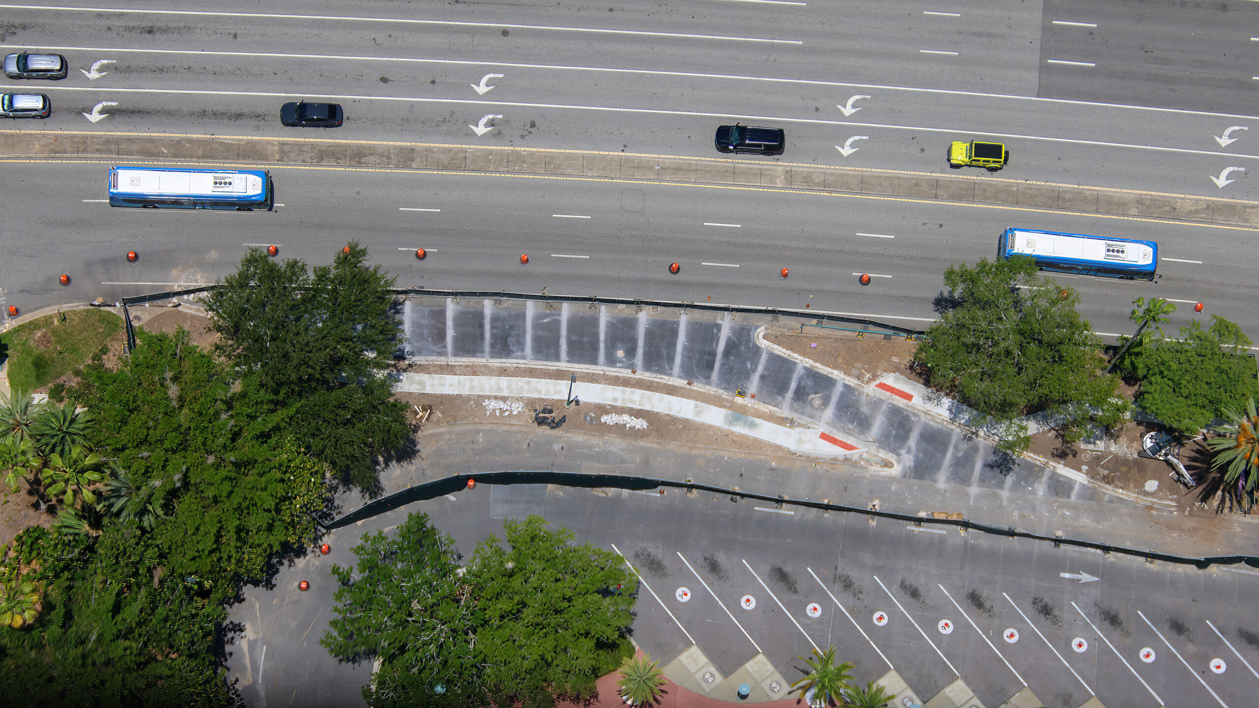 Construction is progressing on a new bus access lane outside Universal CityWalk Orlando, designed to give incoming buses a more direct path into the CityWalk bus terminal loop.