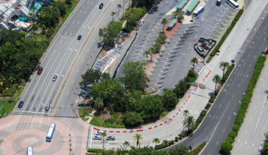 Construction is progressing on a new bus access lane outside Universal CityWalk Orlando, designed to give incoming buses a more direct path into the CityWalk bus terminal loop.