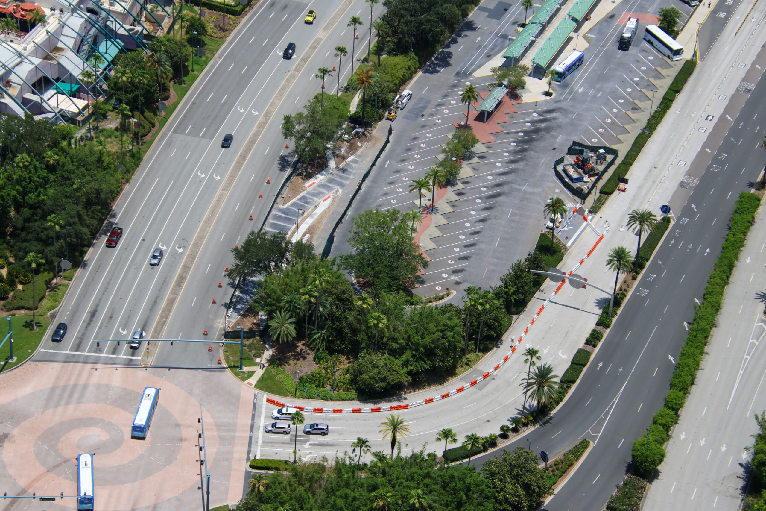 Construction is progressing on a new bus access lane outside Universal CityWalk Orlando, designed to give incoming buses a more direct path into the CityWalk bus terminal loop.