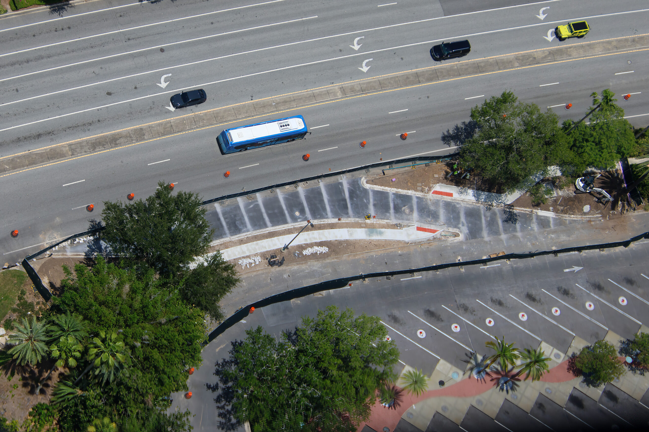 Construction is progressing on a new bus access lane outside Universal CityWalk Orlando, designed to give incoming buses a more direct path into the CityWalk bus terminal loop.