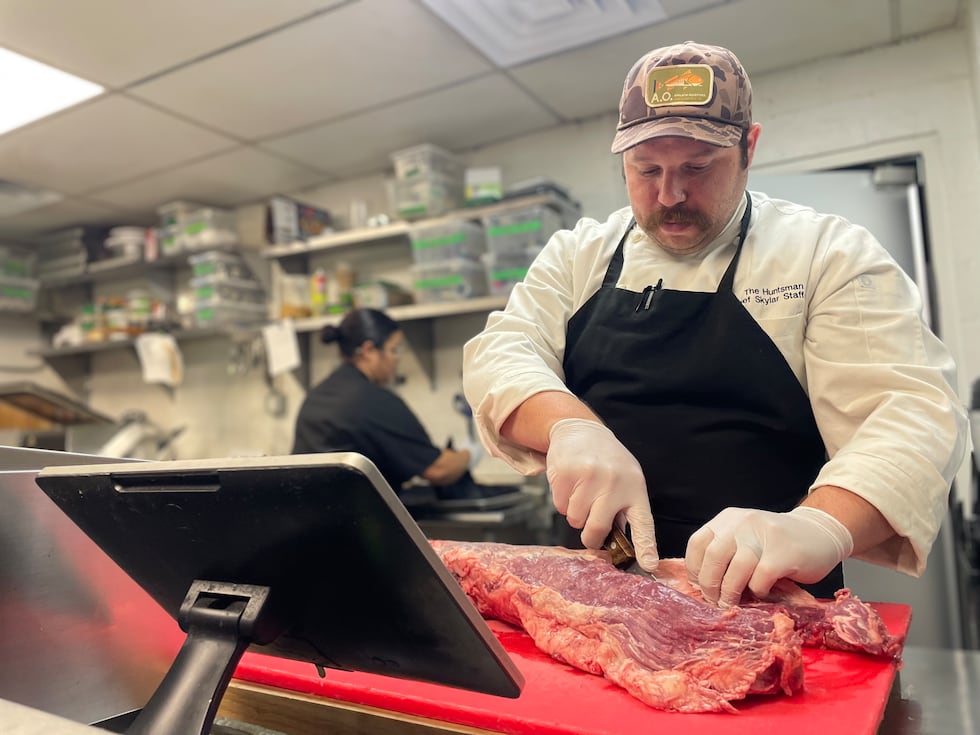 Executive Chef and Co-Owner of The Huntsman, Skylar Stafford, prepares meat ahead of service.