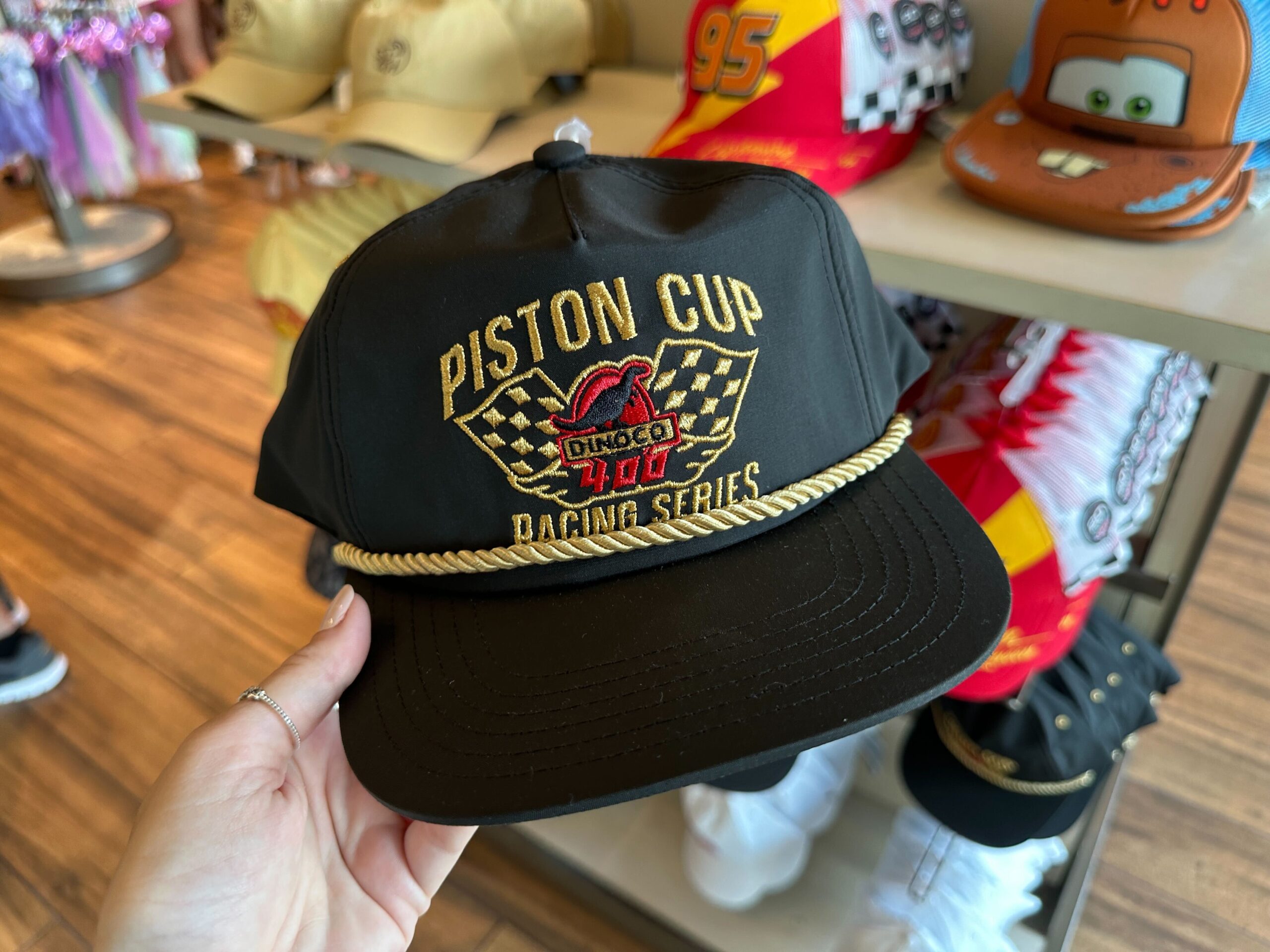 New Mater and Piston Cup Hats Race Into World of Disney at Disney Springs