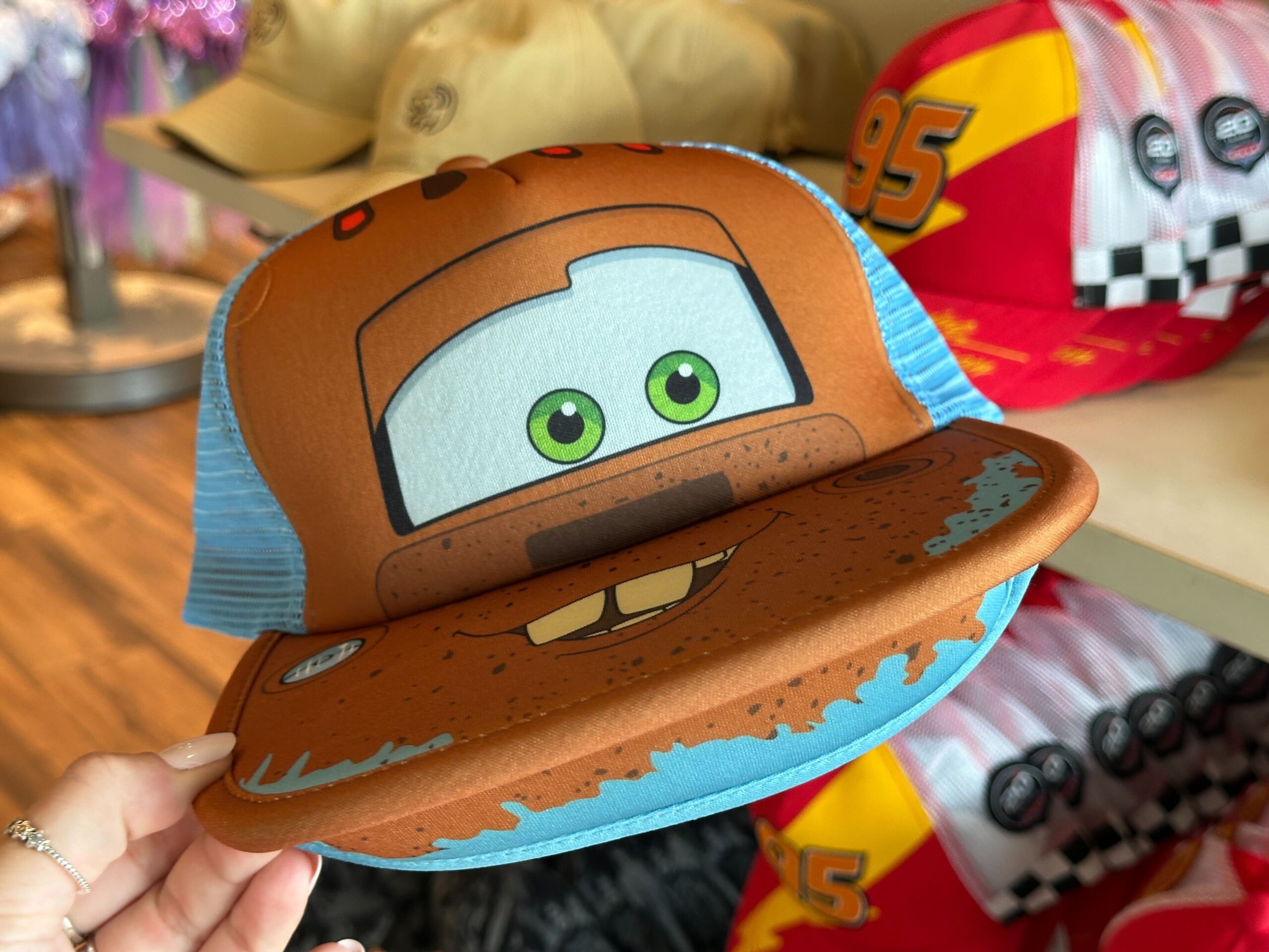 New Mater and Piston Cup Hats Race Into World of Disney at Disney Springs