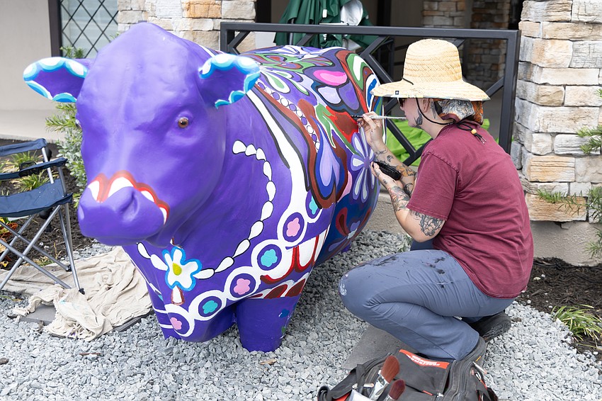 Kaylie Lindsey, a crematory operator for Dignity Memorial and St. Petersburg artist, reimagines a cow outside the company's new events center, Traditions on Tyrone. Kaylie Lindsey, a crematory operator for Dignity Memorial and St. Petersburg artist, reimagines a cow outside the company's new events center, Traditions on Tyrone.
