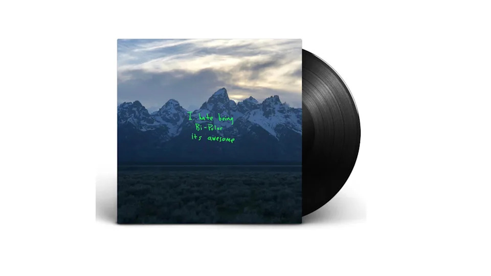 Vinyl record of Kanye West's album "Ye" with a mountain range cover and green handwritten text.
