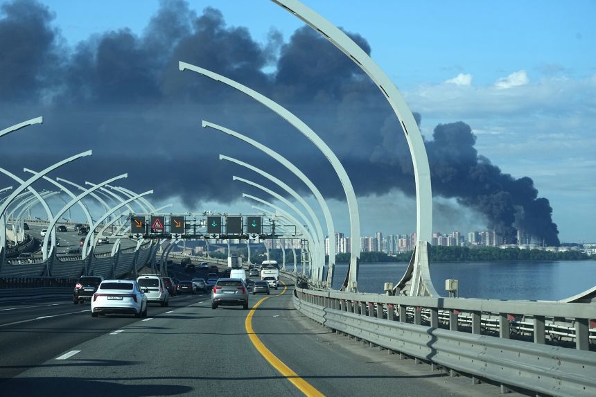 Smoke is seen over the port of St. Petersburg after a Ukrainian drone attack.