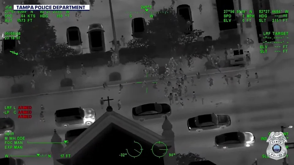<div>Tampa Police Department aerial thermal imaging captures a large crowd scattering across a city street during a nighttime law enforcement response to an unpermitted street takeover event.</div>