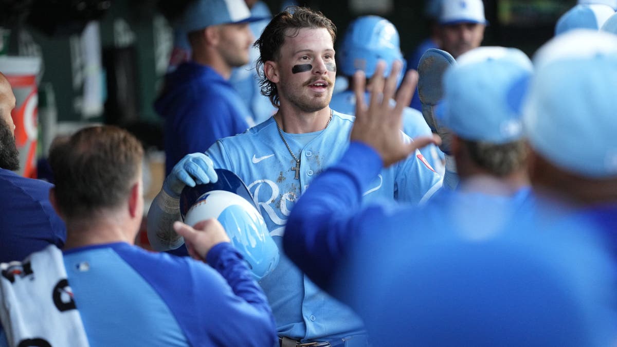 Bobby Witt Jr. celebrating with teammates after scoring a run at Sutter Health Park