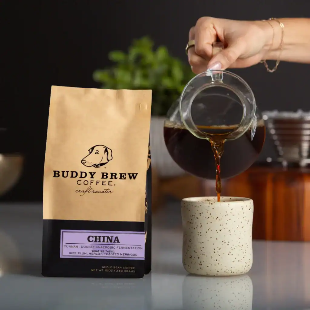 Hand pouring coffee in a cup