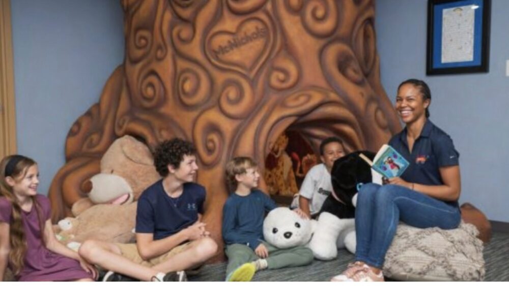 Children and a staff member gather for story time inside a reading space at A Kid's Place of Tampa Bay.