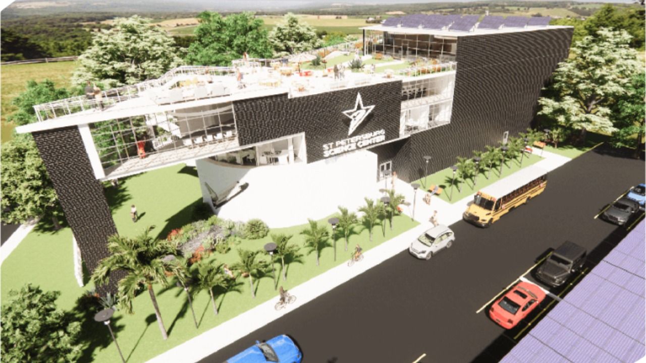 Rendering of the proposed St. Petersburg Science Center redevelopment showing a multi-story AI and education campus with a rooftop event space, restored rotunda, outdoor gathering areas and school bus access.