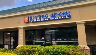 Exterior of a Little Greek Fresh Grill restaurant in a retail strip center with storefront signage and outdoor landscaping.