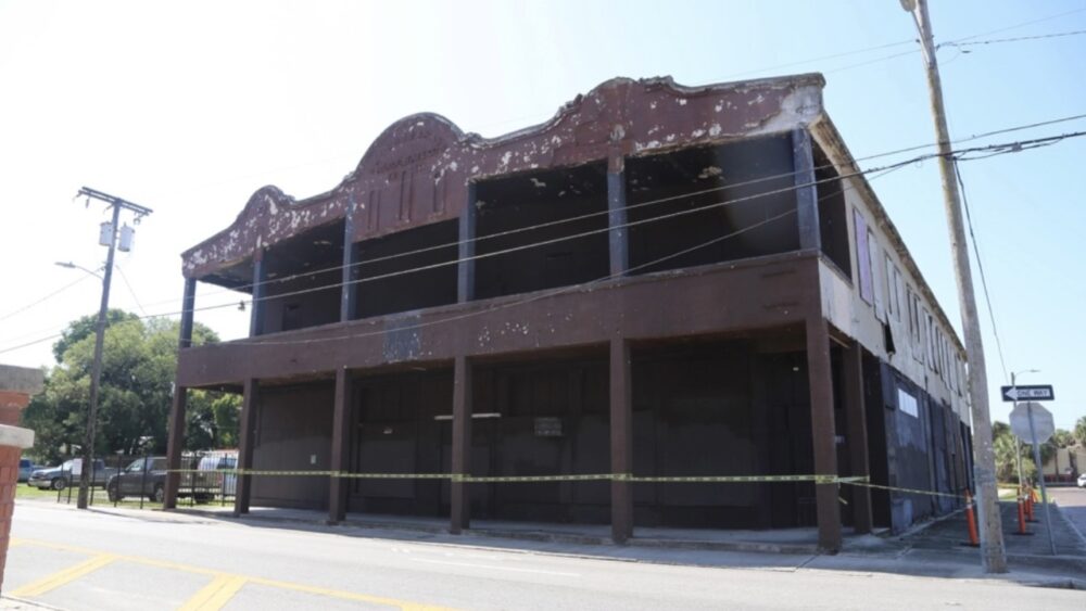 The Sanchez y Haya Building in East Tampa before restoration, showing the weathered historic facade and vacant storefronts.