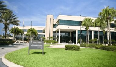 FrankCrum headquarters in Clearwater, Florida, featuring a two-story office building surrounded by palm trees and landscaped grounds.