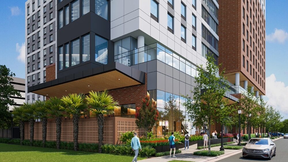 Street-level rendering of the University of Tampa's planned 11-story student housing development with landscaped sidewalks, ground-floor amenities and student housing above.