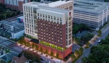 Rendering of the University of Tampa's planned 11-story student housing development at 110 South Boulevard, featuring 238 units, 833 beds and ground-floor dining and student services.
