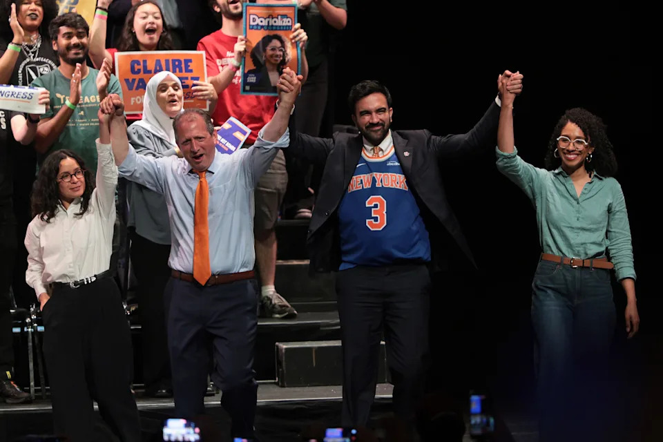 From left, congressional candidate Claire Valdez, congressional candidate Brad Lander, Mayor Zohran Mamdani, and congressional candidate Darializa Avila Chevalier raise their hands during a Get Out the Vote rally on June 18, 2026, in New York City.