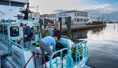 Crew members prepare for departure from the College of Marine Science