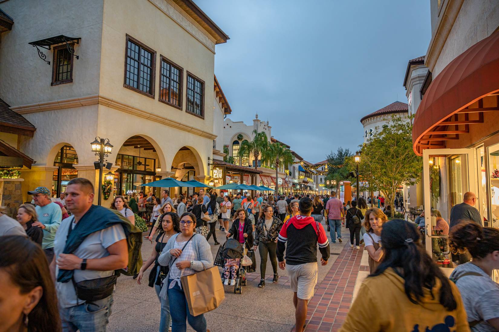 Guests walking along the street at Disney Springs in Orlando, Florida