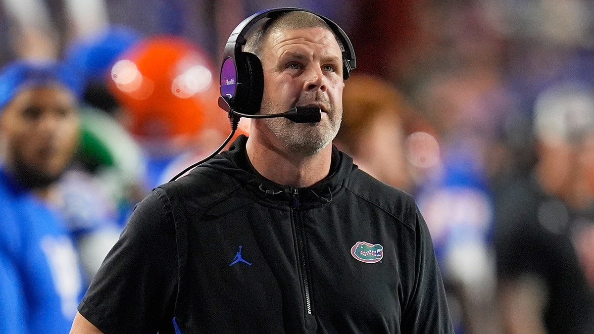 Florida head coach Billy Napier pacing the sideline during a college football game