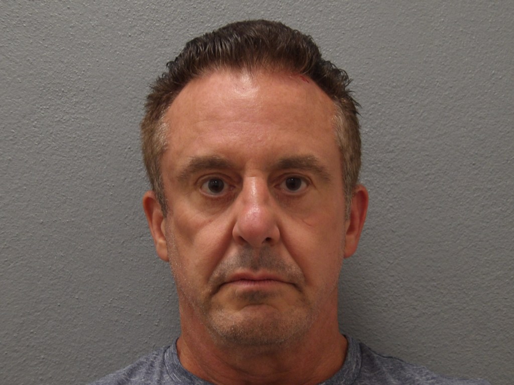 Mugshot of Christopher Michael Veit against a gray background.
